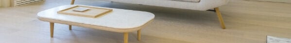 light wood flooring with tan coffee table